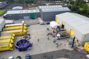 An aerial shot of the W.S. Dennison premises in Antrim showing the 40th anniversary celebration entertainment, including a hog roast, ice cream van, face painting, a portable climbing wall, rodeo bull and two inflatable games